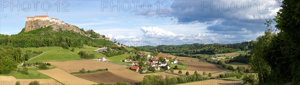 Riegersburg in the evening light, foreground field, panoramic view, cloudy mood, Riegersburg, Styrian volcano country, Styria, Austria, Europe
