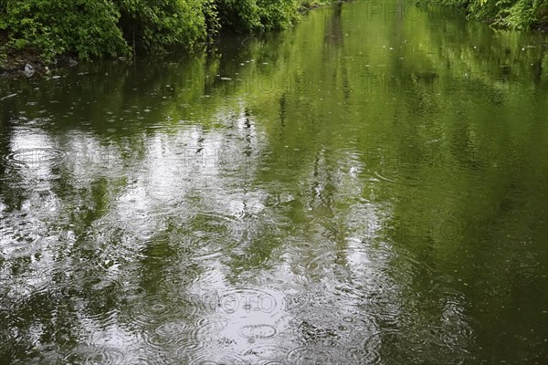 Rain falling on a lake, April weather, Germany, Europe