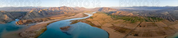 Panorama, Naryn river between mountains and fields, at Toktogul reservoir at sunset, aerial view, Kyrgyzstan, Asia
