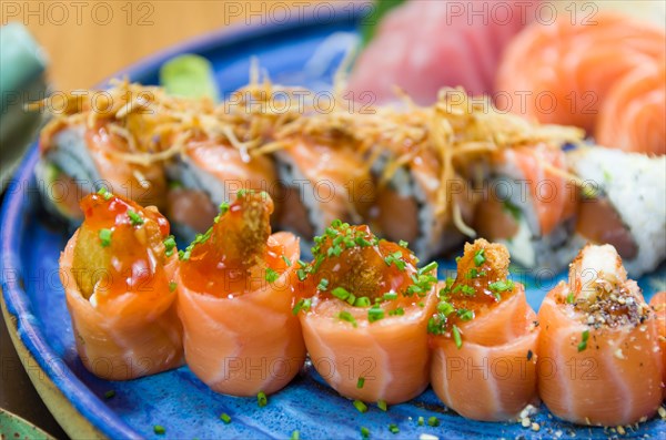 Combined of differents japanese sushi on a elegant blue plate