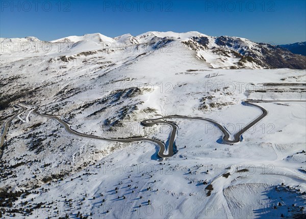 Aerial view of a winding mountain road through a wintry snowy landscape View from Grau Roig in the direction of the serpentine road, Encamp, Andorra, Pyrenees, Europe