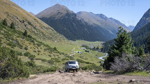UAZ Buchanka, Russian off-road vehicle on 4x4 track, green mountain valley with village Altyn Arashan, Tien Shan Mountains, Kyrgyzstan, Asia