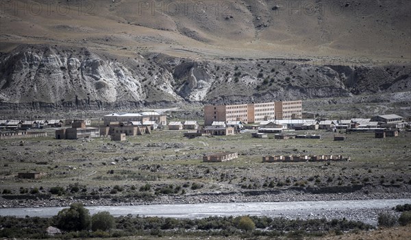 Abandoned buildings in a barren landscape, ghost town of Enilchek in the Tien Shan Mountains, Ak-Su, Kyrgyzstan, Asia
