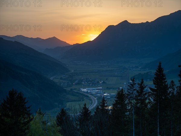 Sunset over mountain peaks, in the valley the village of Traboch, Schoberpass federal road, view from the lowlands, Leoben, Styria, Austria, Europe