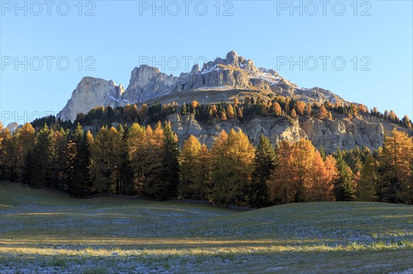 Autumn landscape with sunlit mountain peaks and colourful trees, Italy, Alto Adige, Bolzano province, Dolomites, rose garden, Europe