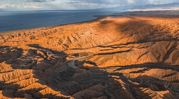 Evening mood, Canyon runs through landscape, Issyk Kul Lake, Dramatic barren landscape of eroded hills, Badlands, Canyon of the Forgotten Rivers, Issyk Kul, Kyrgyzstan, Asia