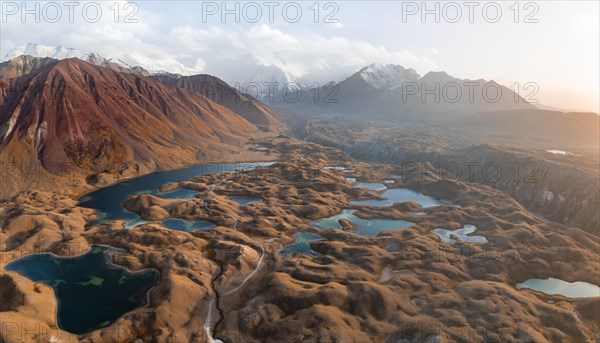 Atmospheric aerial view, high mountain landscape with glacier moraines and mountain lakes, behind Pik Lenin, Trans Alay Mountains, Pamir Mountains, Osher Province, Kyrgyzstan, Asia