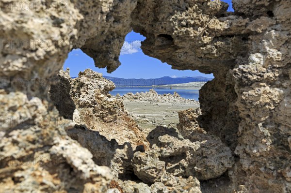 View through a natural rock opening to a quiet landscape with blue sky in the background, Mono Lake, North America, USA, South-West, California, California, North America