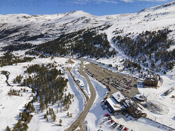Aerial view of a snow-covered ski resort with car park and clear blue sky, Grau Roig, Encamp, Andorra, Pyrenees, Europe