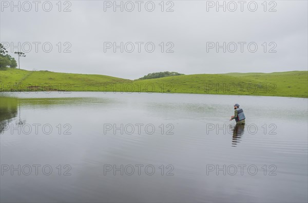 Black bass fisherman fishing with flyfishing, Cambara do sul, Rio Grande do sul, Brazil, South America