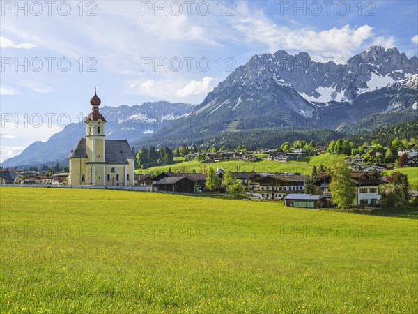 Parish Church of the Holy Cross in Going am Wilden Kaiser, Kaiser Mountains, blue sky and flower meadow, Going am Wilden Kaiser, Tyrol, Austria, Europe