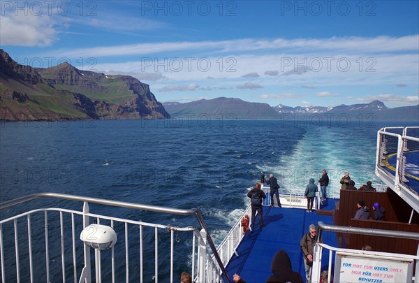 People queuing at the railing of the car ferry Noerroena at the entrance to a fjord, ferry between Denmark and Iceland, Seydifjoerdur, Iceland, Europe