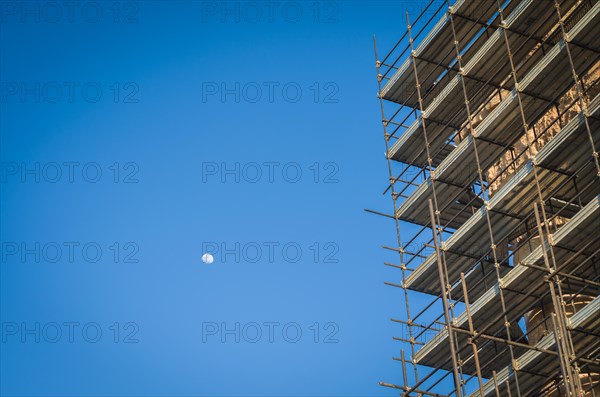 Ruins of Baalbek. Ancient city of Phenicia, located in the Beca valley, Lebanon. Acropolis with Roman remains. Roman tower being restored, moon in the sky