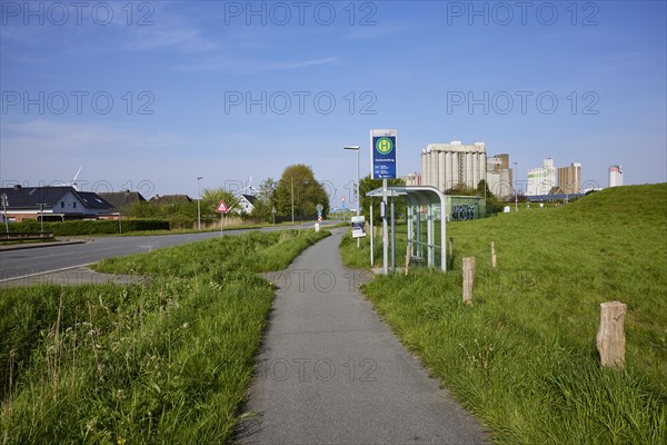 Bus stop Fischersiedlung with cycle path and silos in the harbour of Husum, district of Nordfriesland, Schleswig-Holstein, Germany, Europe