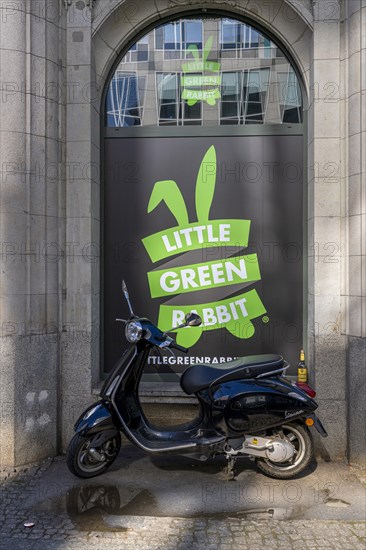 Scooter in front of a window with advertising, Berlin, Germany, Europe