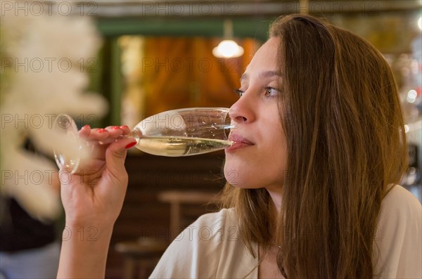 Beautiful woman drinking glass of sparkling wine