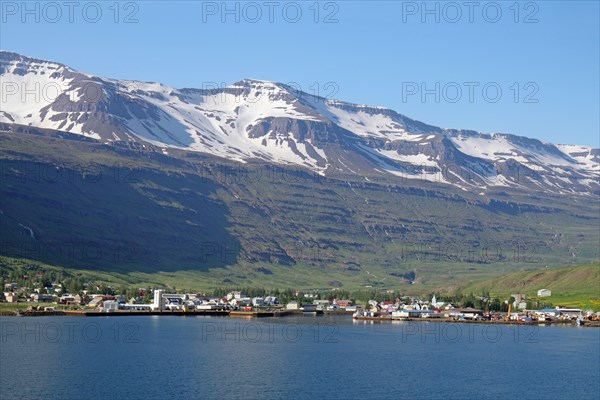 Small village under snow-covered, rugged mountains, ferry town, Seydisfjoerdur, East Iceland, Iceland, Europe