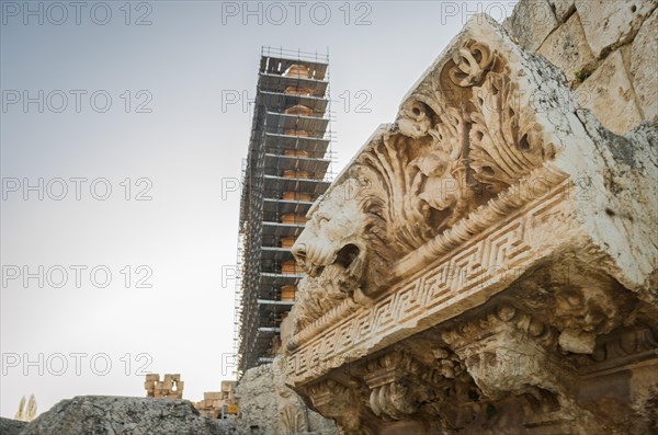 Ruins of Baalbek. Ancient city of Phenicia, located in the Beca valley, Lebanon. Acropolis with Roman remains. Roman tower being restored, moon in the sky
