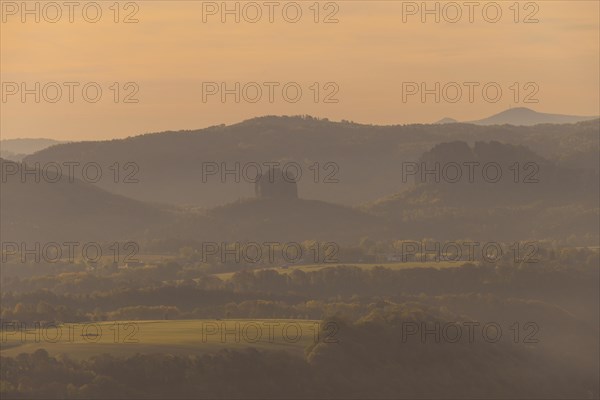 Sunrise on the Lilienstein. The Lilienstein is the most striking and best-known rock in the Elbe Sandstone Mountains. Distant view of the Falkenstein with the Schrammsteine, Ebenheit, Saxony, Germany, Europe