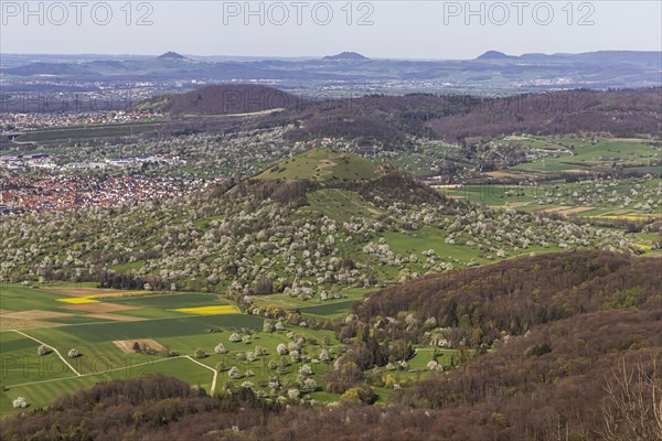 Breitenstein near Ochsenwang, rocky outcrop of the Swabian Alb, 811 metre high rocky plateau, view of the Alb foreland with blossoming fruit trees on orchards in spring, Three Imperial Mountains Hohenstaufen, Rechberg and Stuifen, Bissingen an der Teck, Baden-Wuerttemberg, Germany, Europe