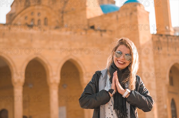 Blonde tourist in front of the Mohammad Al-Amin Mosque, concept of spirituality