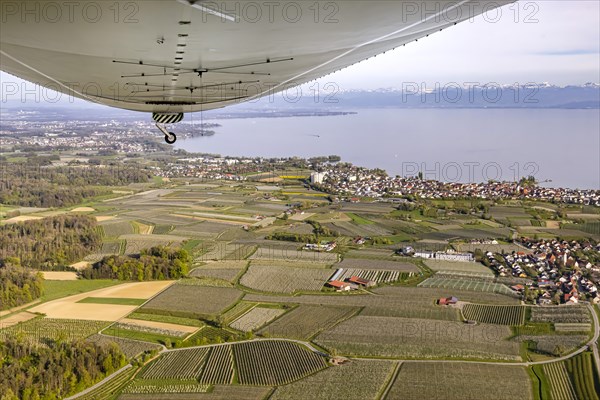 Flight in a zeppelin along the shore of Lake Constance, aerial view, Immenstaad with marina and landing stage for scheduled boats, Swiss Alps with snow, Immenstaad, Baden-Wuerttemberg, Germany, Europe