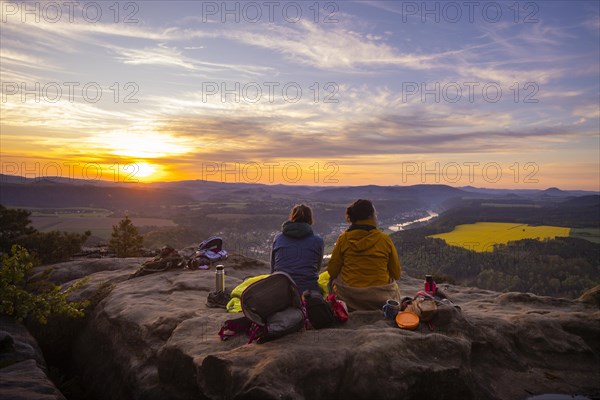 Sunrise on the Lilienstein. The Lilienstein is the most striking and best-known rock in the Elbe Sandstone Mountains. View of the Elbe valley towards Bad Schandau. Tourists enjoy a sunrise breakfast high above the Elbe, Ebenheit, Saxony, Germany, Europe