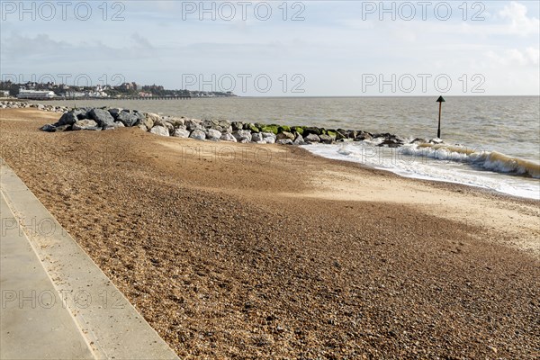 Rock armour groynes building beach sediment, North Sea coast, Felixstowe, Suffolk, England, UK