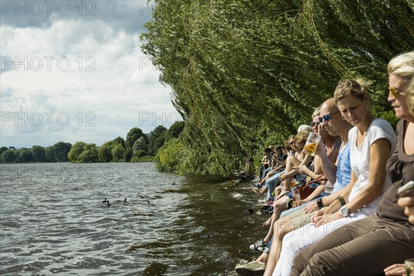 People sitting in the sun by the water, Summer, Outer Alster Lake, Hamburg, Northern Germany, Germany, Europe