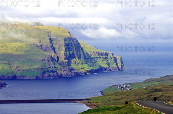 View over high mountains, cliffs and a mountain road, Eidi, Tjornuvik, Faroe Islands, Denmark, Europe
