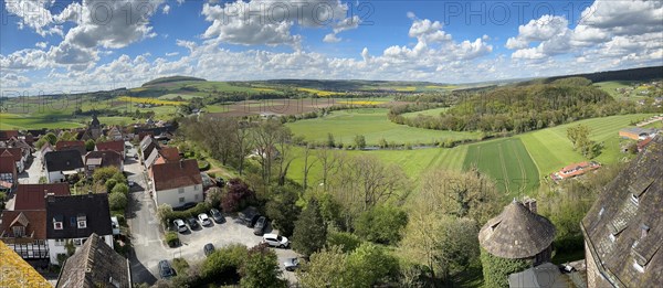 Panoramic view from large castle tower tower of 13th century castle today castle hotel Trendelburg on village Trendelburg and fields in spring, lower right small castle tower, Weserbergland, Hesse, Germany, Europe
