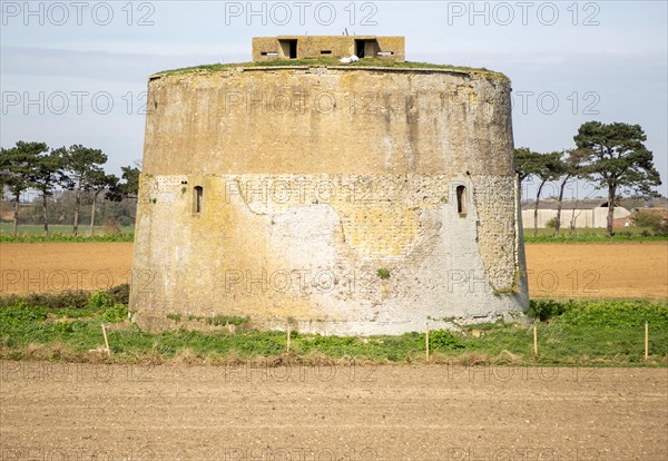 Napoleonic War Martello tower Z in field Alderton, Suffolk, England, UK with Second World War pillbox