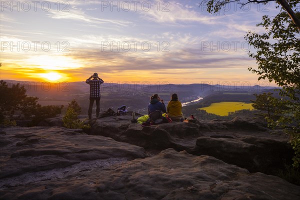 Sunrise on the Lilienstein. The Lilienstein is the most striking and best-known rock in the Elbe Sandstone Mountains. View of the Elbe valley towards Bad Schandau. Tourists enjoy a sunrise breakfast high above the Elbe, Ebenheit, Saxony, Germany, Europe