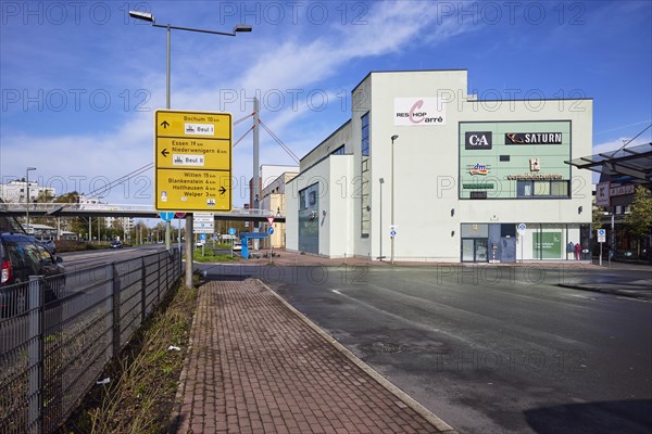 Reschop Carre shopping centre with Martin-Luther-Strasse, pedestrian bridge and yellow sign in Hattingen, Ennepe-Ruhr district, North Rhine-Westphalia, Germany, Europe