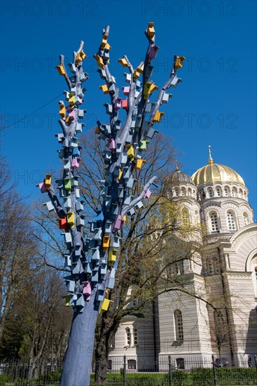 Cathedral of the Nativity of Christ, the largest Russian Orthodox church in the Baltic States, stands in Riga's Esplanade Park, in front of a tree with a birdhouse, Riga, Latvia, Europe