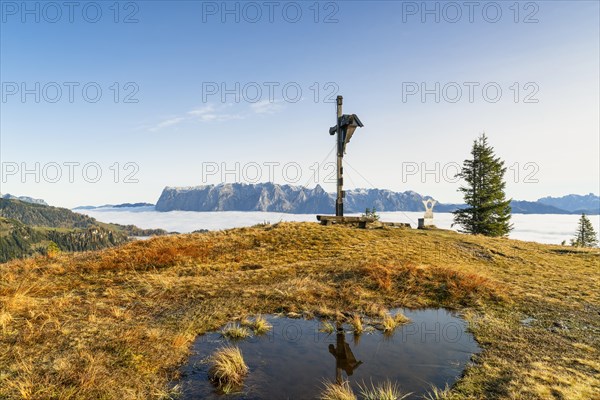 Cross on the Hochkeil with the Tennengebirge in the background, autumn, fog in the valley, Muehlbach am Hochkoenig, Pongau, Salzburg, Austria, Europe