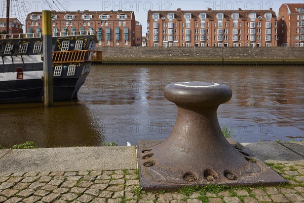 Bollards on the banks of the Weser and the houses on the Teerhof in Bremen, Hanseatic City, State of Bremen, Germany, Europe