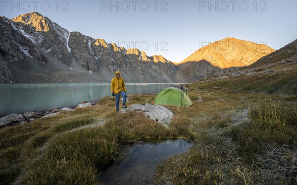 Hikers camping in the wilderness, mountain lake in the Tien Shan, Lake Ala-Kul, Kyrgyzstan, Asia