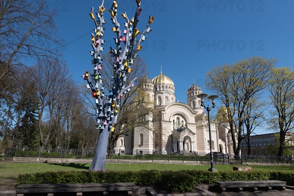 Cathedral of the Nativity of Christ, the largest Russian Orthodox church in the Baltic States, stands in Riga's Esplanade Park, in front of a tree with a birdhouse, Riga, Latvia, Europe