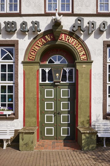 Entrance door of the Swan pharmacy in the city centre of Husum, district of Nordfriesland, Schleswig-Holstein, Germany, Europe
