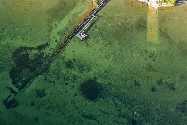 Flight in a zeppelin along the shore of Lake Constance, aerial view, shore area with turquoise water, jetty and sewage pipe, Friedrichshafen, Baden-Wuerttemberg, Germany, Europe