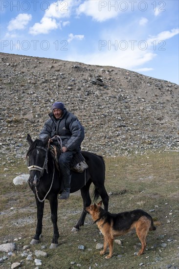 Nomadic life on a plateau, shepherd on horse with dog, Tian Shan Mountains, Jety Oguz, Kyrgyzstan, Asia