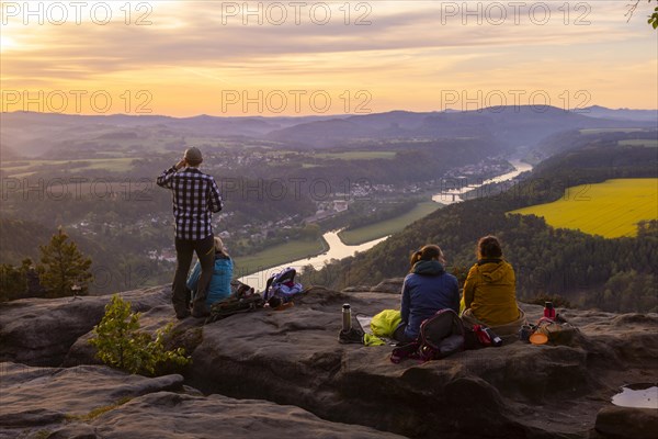 Sunrise on the Lilienstein. The Lilienstein is the most striking and best-known rock in the Elbe Sandstone Mountains. View of the Elbe valley towards Bad Schandau. Tourists enjoy a sunrise breakfast high above the Elbe, Ebenheit, Saxony, Germany, Europe