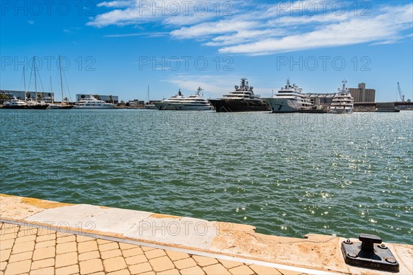 View of the marina of Tarragona with luxury yachts, clear blue sky and calm sea, Tarragona, Spain, Europe