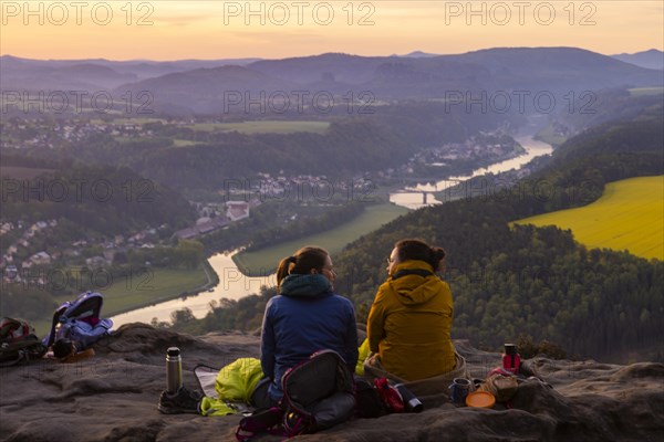 Sunrise on the Lilienstein. The Lilienstein is the most striking and best-known rock in the Elbe Sandstone Mountains. View of the Elbe valley towards Bad Schandau. Tourists enjoy a sunrise breakfast high above the Elbe, Ebenheit, Saxony, Germany, Europe