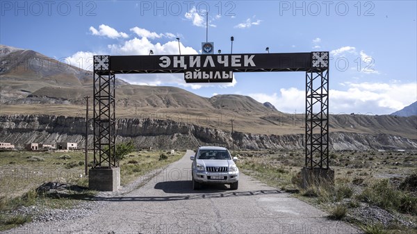 Car at the entrance to the ghost town of Enilchek in the Tien Shan Mountains, Ak-Su, Kyrgyzstan, Asia