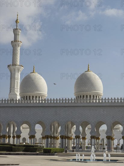 White mosque complex with elegant domes and a minaret under a clear sky, beautiful mosque with white domes and beautiful minarets, abu dhabi, arab emirates