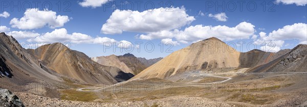 Mountain road through a colourful mountain landscape, view from the Chong Ashuu Pass, Tien Shan, Kyrgyzstan, Asia