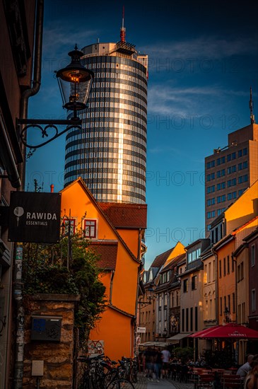 The restaurant alleyway Wagnergasse with the Jentower in the background at sunset and blue sky, Jena, Thuringia, Germany, Europe