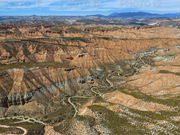 Extensive desert landscape with red rocks and canyons, criss-crossed by serpentines, aerial view, Los Coloraos, Grand Canyon of Andalusia, Gorafe desert, Granada, Andalusia, Spain, Europe